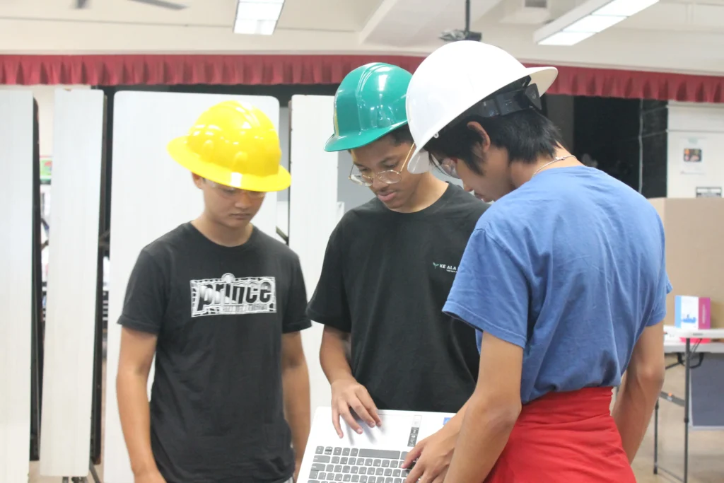 A student piloting a drone with a handheld controller