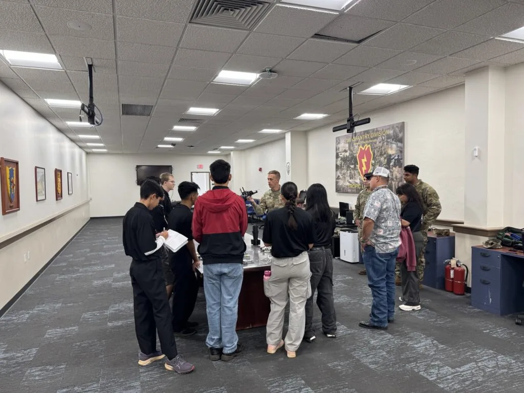 Students exploring military technology displays at Schofield Barracks
