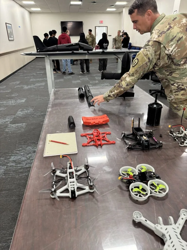 A student examining drone equipment during the site visit