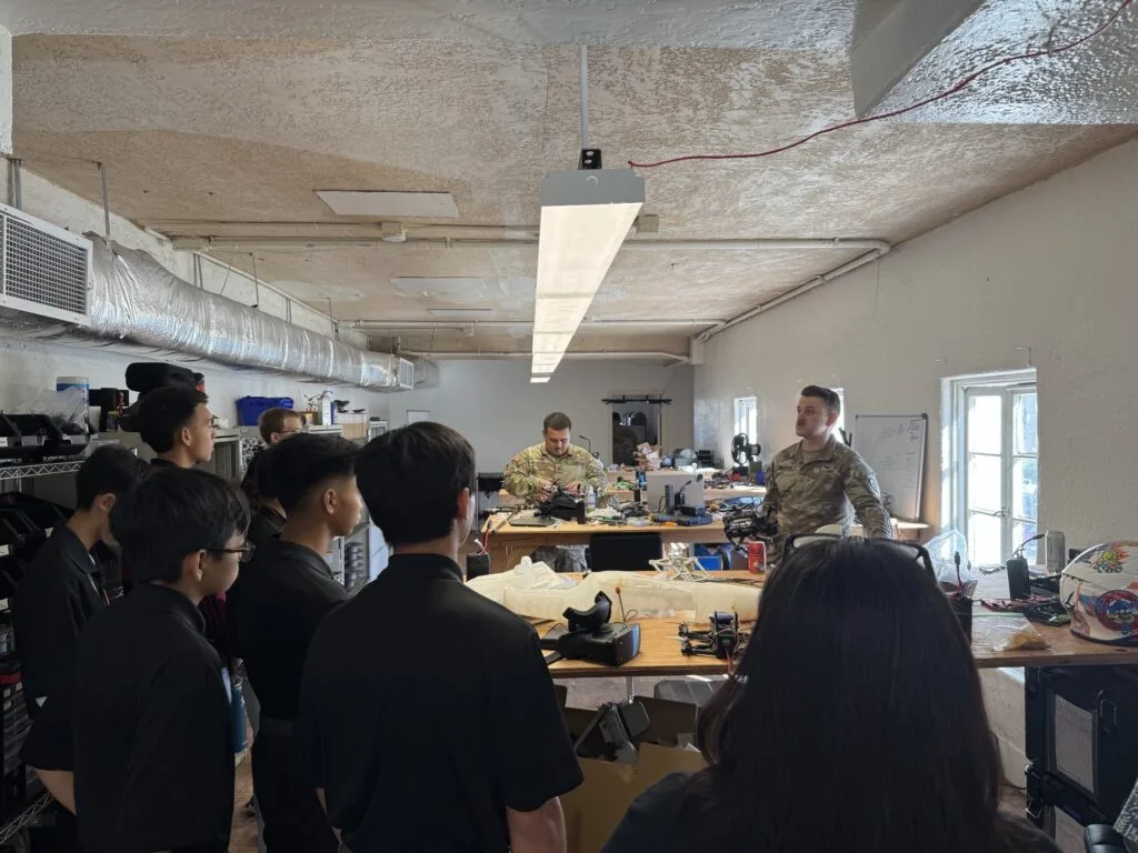 Students listening to military technologists during the visit